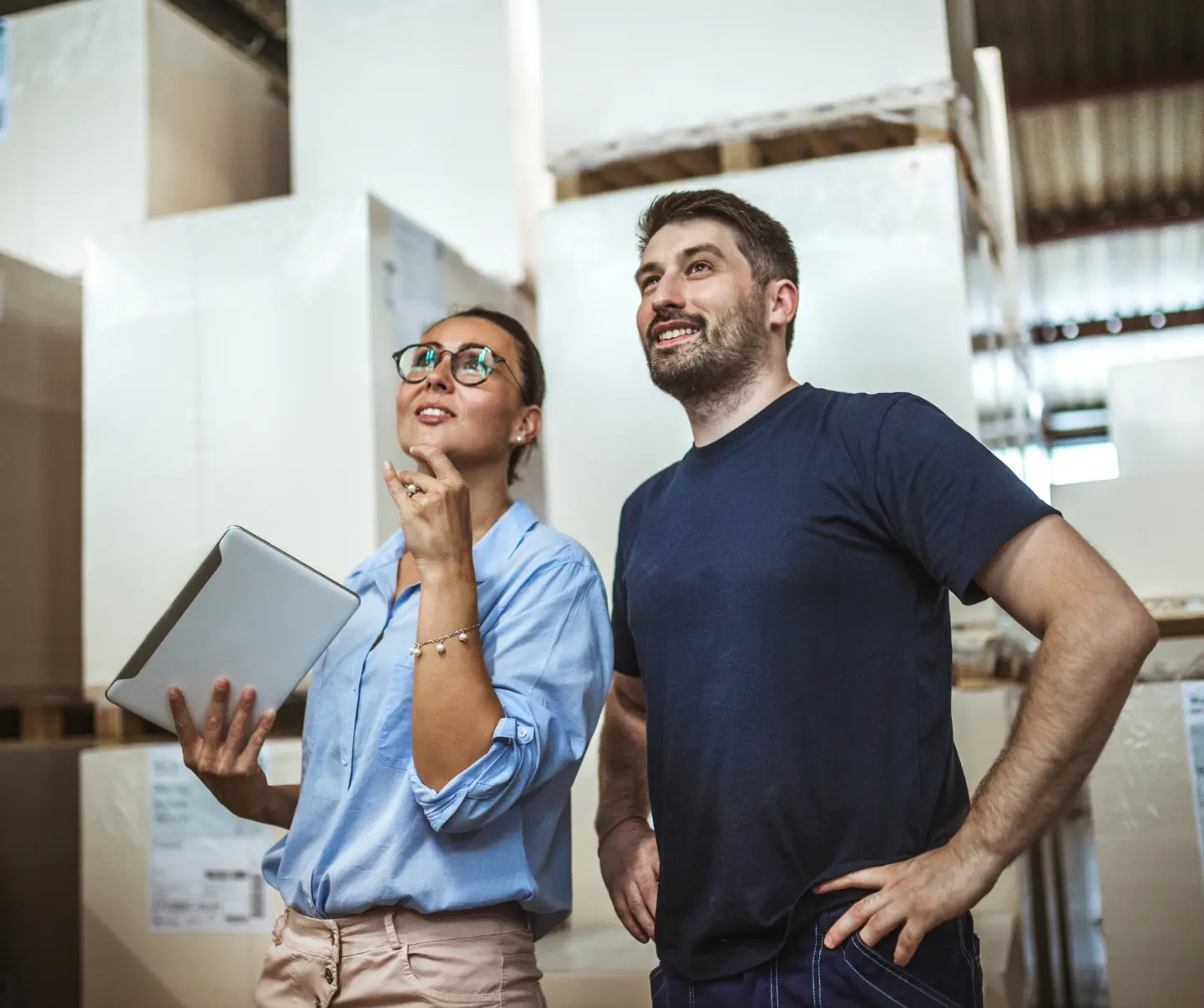 Professional discussing operation details in a warehouse.